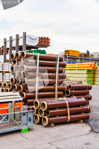 Image of Several pipes stacked in yard