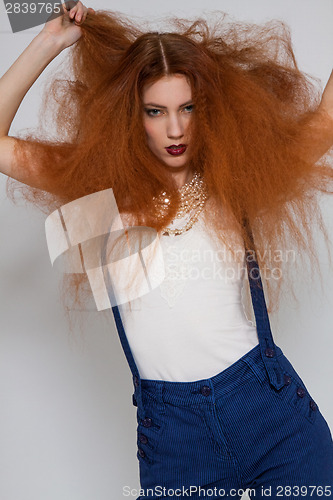 Image of Female model playing with frizzy hair