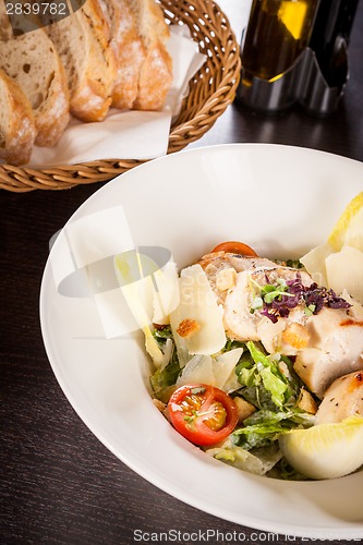 Image of tasty fresh caesar salad with grilled chicken and parmesan 