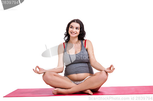 Image of Pregnant woman practising yoga and meditating