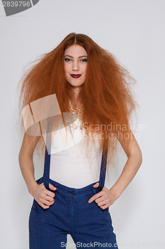 Image of Female model playing with frizzy hair