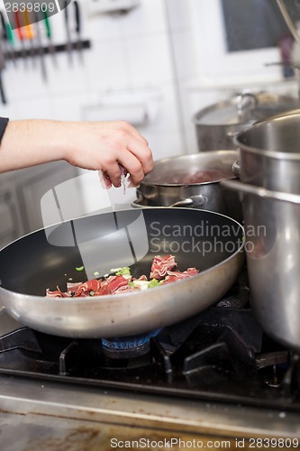 Image of Chef or braising meat in a frying pan