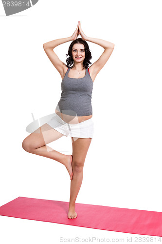 Image of Active young pregnant woman doing yoga