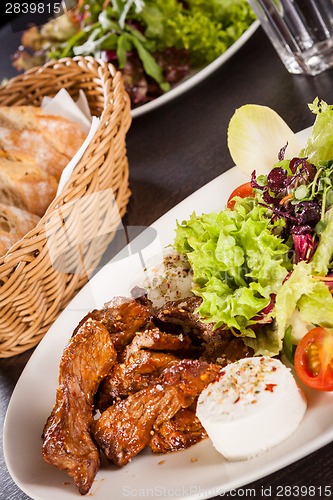 Image of grilled beef stripes fresh salad and goat cheese