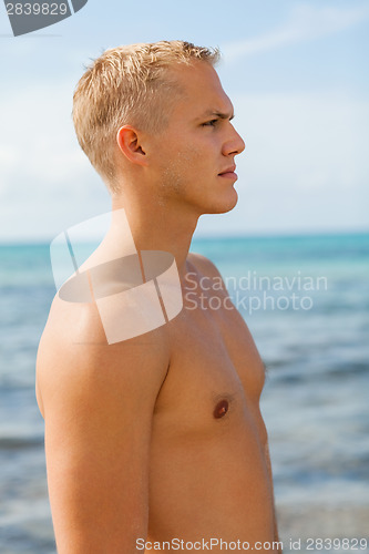 Image of Man in blue swim shorts in the beach
