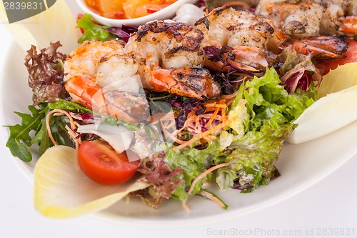 Image of Grilled prawns with endive salad and jacket potato