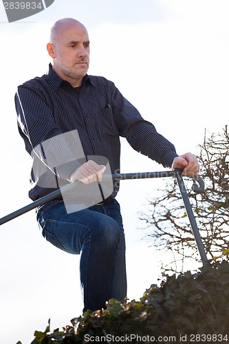 Image of Thoughtful man sitting on a flight of steps