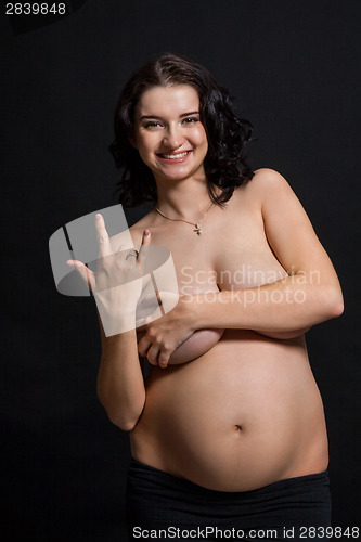 Image of Pregnant woman posing nude