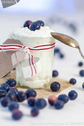 Image of Jar of clotted cream or yogurt with blueberries