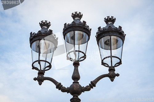 Image of Old wrought iron lamp on a building exterior