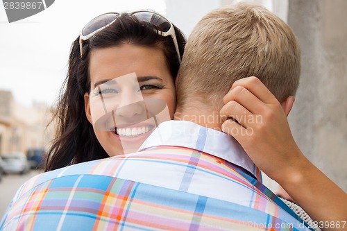 Image of Beautiful radiant woman hugging her boyfriend