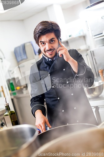 Image of Chef taking a call on his smartphone