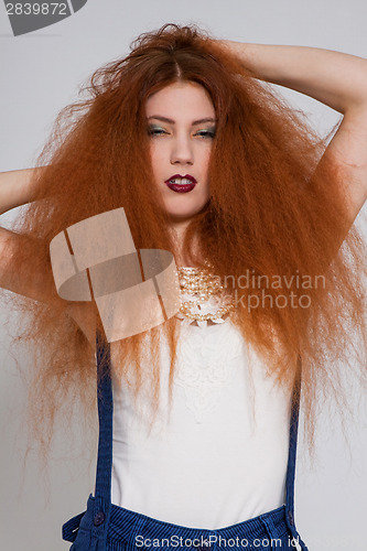 Image of Female model playing with frizzy hair