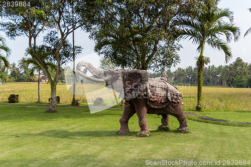 Image of Elephant statue standing on a lawn at a park