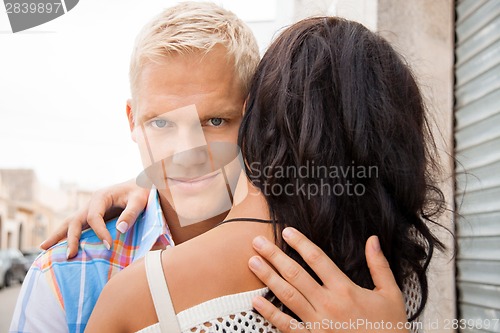 Image of Romantic handsome man hugging his girlfriend