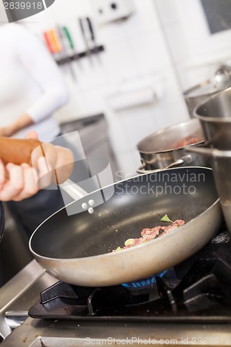 Image of Chef or braising meat in a frying pan