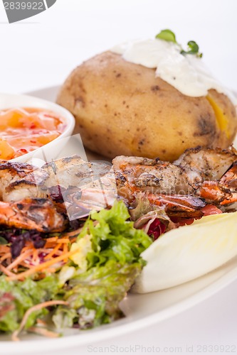 Image of Grilled prawns with endive salad and jacket potato