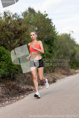 Image of Fit young woman jogging