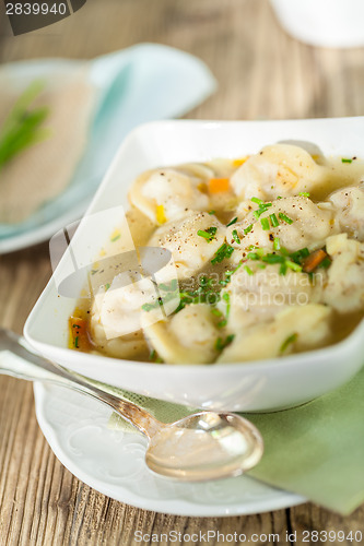 Image of Dish of savory pork tortellini in broth pelmeni russian