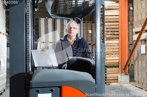 Image of Posing reach truck driver