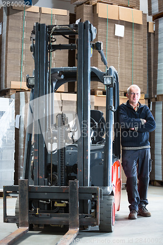 Image of Posing alongside a forklift