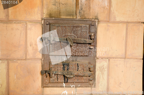 Image of two closed old rustic furnace doors 