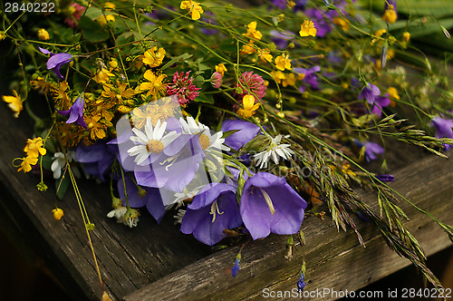 Image of Bouquet of wildflowers on wooden boards