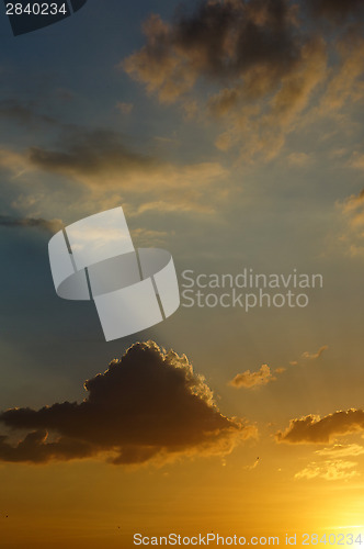 Image of Rays of the setting sun illuminates the clouds