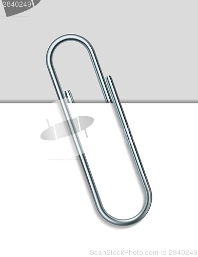Image of Metal paperclip and paper