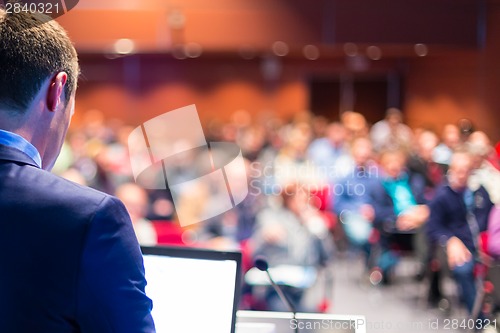 Image of Speaker at Business Conference and Presentation.