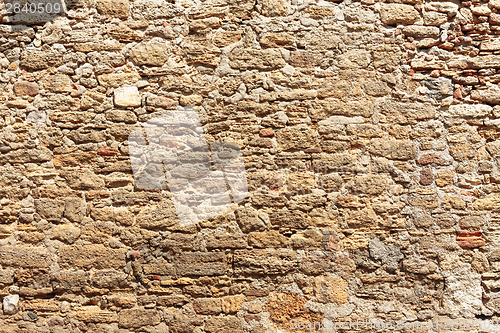 Image of Old Wall Constructed Of Stone Bricks.