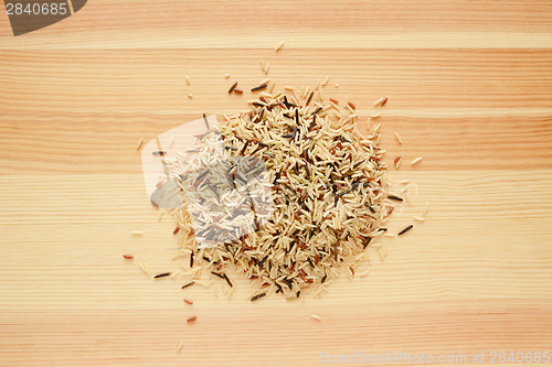 Image of Wild rice, brown basmati and red camargue grains on wood