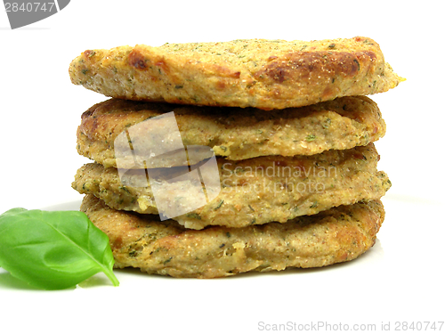 Image of potato dough cakes with basil lying upon another