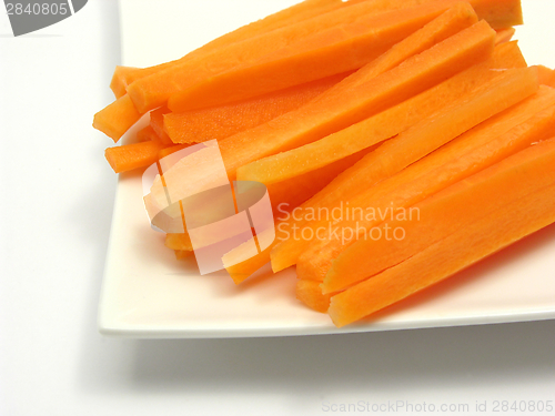 Image of Julienne carrots on a white plate and white background