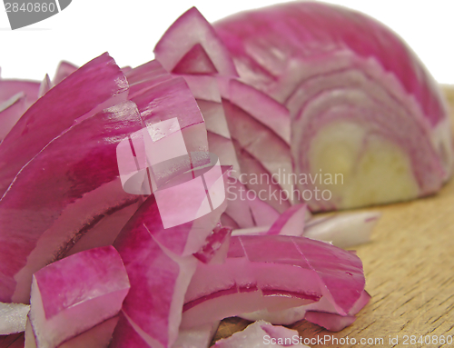 Image of Diced red onion on a brown wooden plate