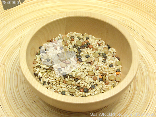 Image of Wooden bowl with rice and lens mixture on bamboo plate