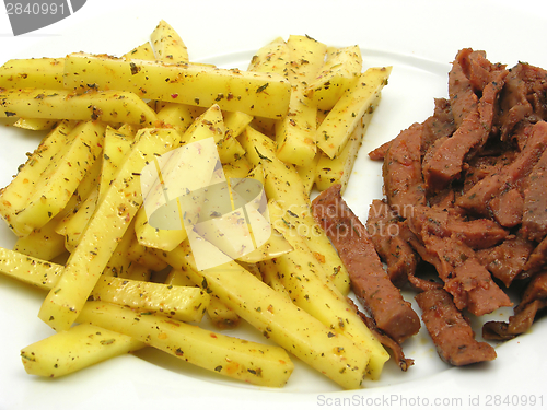 Image of Soy Geschnetzeltes and french fries on white plate