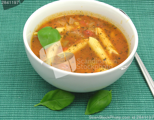 Image of Noodle soup with tomatoes and herbs on green