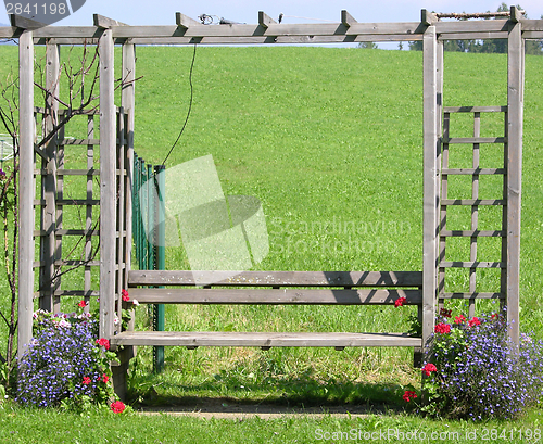 Image of Wooden seating bench in the green in Freiland Austria