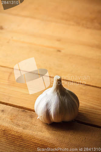 Image of Raw Garlic On Wooden Background