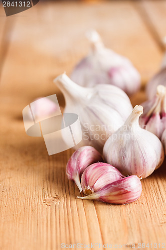 Image of Raw Garlic On Wooden Background