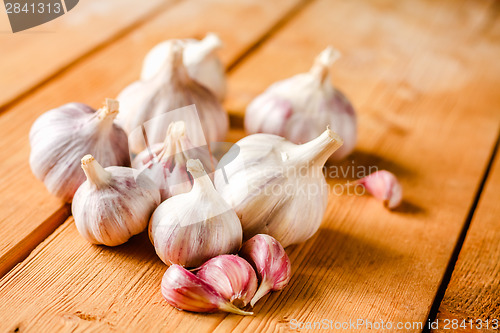 Image of Raw Garlic On Wooden Background