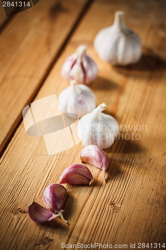 Image of Raw Garlic On Wooden Background