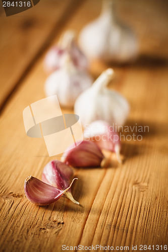 Image of Raw Garlic On Wooden Background