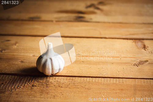 Image of Raw Garlic On Wooden Background