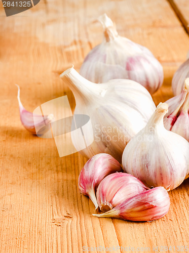 Image of Raw Garlic On Wooden Background