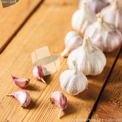 Image of Raw Garlic On Wooden Background