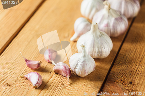 Image of Raw Garlic On Wooden Background