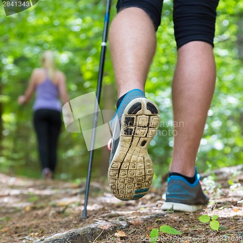 Image of Young couple hiking in nature. Sport and exercise.