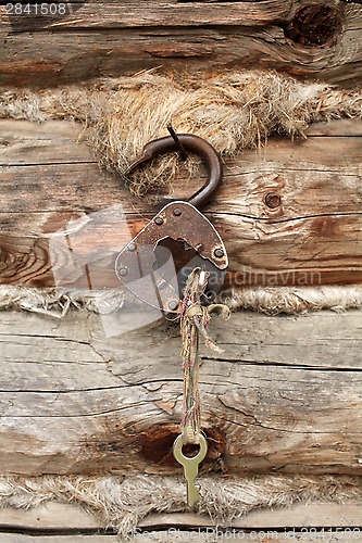 Image of  old padlock with key